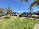 Expansive green community lawn with contemporary homes and mature trees in a landscaped neighborhood at 483 Fairview Hills St, Las Vegas, NV 89138