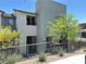 Modern two-story home with desert landscaping, a balcony, and metal fence on a sunny day at 483 Fairview Hills St, Las Vegas, NV 89138
