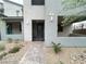 Stylish home entrance with gray stucco walls, low-maintenance landscaping, and a secure gated walkway at 483 Fairview Hills St, Las Vegas, NV 89138