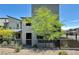 Contemporary two-story home featuring a gray exterior, modern landscaping, and a gated front yard at 483 Fairview Hills St, Las Vegas, NV 89138