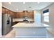 Bright kitchen features stainless steel appliances, granite counters, and brown cabinets at 483 Fairview Hills St, Las Vegas, NV 89138