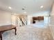Spacious living area with stairs, plush carpet, and an open layout to the kitchen at 483 Fairview Hills St, Las Vegas, NV 89138