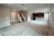 Open-concept living room with modern carpeting, staircase, and recessed lighting adjacent to the kitchen at 483 Fairview Hills St, Las Vegas, NV 89138