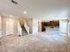 Bright living room featuring stairs, plush carpet, and seamless access to the kitchen at 483 Fairview Hills St, Las Vegas, NV 89138