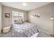 Comfortable bedroom features neutral tones, with ample natural light and soft carpet at 49 Alamere Falls Dr, Las Vegas, NV 89138