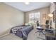 Comfortable bedroom featuring a bed, work space, and neutral color palette at 49 Alamere Falls Dr, Las Vegas, NV 89138