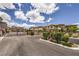 View of community entrance with gate, landscaping, trees, and well-maintained surroundings at 49 Alamere Falls Dr, Las Vegas, NV 89138