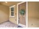 Exterior shot of entry door with window and verdant leafy wreath at 49 Alamere Falls Dr, Las Vegas, NV 89138