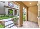 Covered entryway featuring brick flooring with inviting views of landscaped community at 49 Alamere Falls Dr, Las Vegas, NV 89138