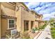 Inviting front exterior of townhome featuring covered entry and verdant landscaping at 49 Alamere Falls Dr, Las Vegas, NV 89138
