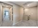Upstairs hallway with carpet flooring leading to a laundry room and other rooms at 49 Alamere Falls Dr, Las Vegas, NV 89138