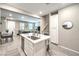 A view of kitchen island featuring a stainless steel sink, breakfast bar, and open floor plan at 49 Alamere Falls Dr, Las Vegas, NV 89138