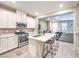 Stylish kitchen with an island, stainless steel appliances, and open layout to living area at 49 Alamere Falls Dr, Las Vegas, NV 89138