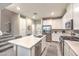 Modern kitchen boasts stainless steel appliances, quartz countertops, and a large island at 49 Alamere Falls Dr, Las Vegas, NV 89138