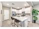 Bright, modern kitchen with a quartz island, stainless appliances, and sleek white cabinetry at 49 Alamere Falls Dr, Las Vegas, NV 89138