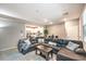 Open-concept living room featuring a large sectional sofa and access to the kitchen at 49 Alamere Falls Dr, Las Vegas, NV 89138