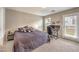 Bright bedroom featuring neutral walls, balcony access, bed and a work station at 49 Alamere Falls Dr, Las Vegas, NV 89138