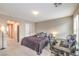 Neutral-toned bedroom with a bed, work station and a comfortable carpet at 49 Alamere Falls Dr, Las Vegas, NV 89138