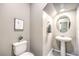 Elegant powder room with a pedestal sink and decorative accents at 49 Alamere Falls Dr, Las Vegas, NV 89138