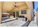 Backyard patio with fan and built-in seating offers a relaxing outdoor space at 4937 Teal Petals St, North Las Vegas, NV 89081