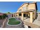 Spacious backyard featuring covered patio, synthetic grass, shed, and landscaping at 4937 Teal Petals St, North Las Vegas, NV 89081