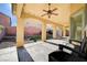 Inviting covered patio with ceiling fan overlooking the backyard and landscape at 4937 Teal Petals St, North Las Vegas, NV 89081