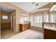 Spacious bathroom with a large soaking tub, double sinks, and neutral tile flooring at 4937 Teal Petals St, North Las Vegas, NV 89081