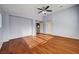 Bedroom with a ceiling fan, hardwood floors, and a doorway to the bathroom at 4937 Teal Petals St, North Las Vegas, NV 89081