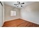 Cozy bedroom with hardwood floors, a ceiling fan, and a window for natural light at 4937 Teal Petals St, North Las Vegas, NV 89081