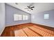 Bedroom with a ceiling fan and natural light, featuring hardwood floors at 4937 Teal Petals St, North Las Vegas, NV 89081