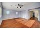 Bedroom with a ceiling fan and natural light, adjacent to hallway with open doors at 4937 Teal Petals St, North Las Vegas, NV 89081