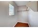 Small walk-in closet with hardwood floors and a bright window with blinds at 4937 Teal Petals St, North Las Vegas, NV 89081