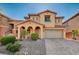 Charming two-story home featuring a stucco exterior, arched entryway, and a well-maintained landscaped yard at 4937 Teal Petals St, North Las Vegas, NV 89081