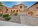 Inviting two-story home with a brick-paved driveway, well-kept landscaping, and a warm, neutral color palette at 4937 Teal Petals St, North Las Vegas, NV 89081
