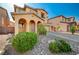 Charming home with a covered entrance, beautiful landscaping, and a welcoming front yard at 4937 Teal Petals St, North Las Vegas, NV 89081
