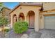 Inviting front porch with archways, stone landscaping, and a welcoming entrance at 4937 Teal Petals St, North Las Vegas, NV 89081