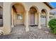 Covered porch showcasing elegant columns, a paved walkway, and a secure entryway at 4937 Teal Petals St, North Las Vegas, NV 89081