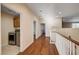 Open hallway featuring hardwood floors, neutral paint, and a laundry area at 4937 Teal Petals St, North Las Vegas, NV 89081