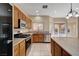 Open-concept kitchen featuring stainless steel appliances, granite countertops, and views of the backyard at 4937 Teal Petals St, North Las Vegas, NV 89081