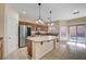 Spacious kitchen with granite countertops, stainless steel appliances, and a center island, perfect for cooking and gathering at 4937 Teal Petals St, North Las Vegas, NV 89081