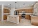 Well-equipped kitchen featuring stainless steel appliances, ample cabinet space, and a center island with pendant lighting at 4937 Teal Petals St, North Las Vegas, NV 89081