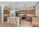 Traditional kitchen features wood cabinets, stainless steel appliances, and a convenient center island at 4937 Teal Petals St, North Las Vegas, NV 89081