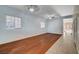 Bright living room featuring hardwood floors, neutral paint, ceiling fan, and natural lighting at 4937 Teal Petals St, North Las Vegas, NV 89081