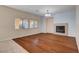 Cozy living room with a fireplace and hardwood flooring, perfect for relaxation and entertaining at 4937 Teal Petals St, North Las Vegas, NV 89081