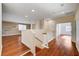 Upstairs loft space with hardwood floors, custom shelving, and a view of the neighborhood at 4937 Teal Petals St, North Las Vegas, NV 89081