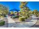 Park view with walkways, play area with shade structure, and mature landscaping for a refreshing outdoor experience at 4937 Teal Petals St, North Las Vegas, NV 89081