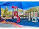 Well maintained playground featuring a shade structure, multiple slides, and learning tools for young to enjoy at 4937 Teal Petals St, North Las Vegas, NV 89081