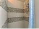 Shower with modern gray and white mosaic tile and a rain style shower head at 4998 Schumann Dr, Las Vegas, NV 89146