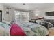 Bright bedroom offering a bed, dresser, TV and multiple windows providing ample natural light at 4998 Schumann Dr, Las Vegas, NV 89146
