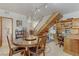 Open-concept dining room, featuring a large round table, built-in desk, and a staircase at 4998 Schumann Dr, Las Vegas, NV 89146